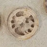 Seated figure with bear