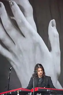 Curtis performing with Interpol in 2015