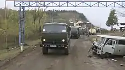 A convoy of Russian peacekeepers driving past an Azerbaijani checkpoint at the northern entrance to Shusha.