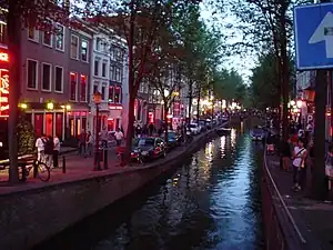 The red-light district in Amsterdam (2003). Red is the sex industry's preferred color in many cultures, due to being strongly associated with passion, love and sexuality.: 39–63 