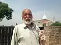 An Indian Christian in front of Methodist Church at Ranbirpura