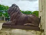 Bronze lion statue and part of Christopher Columbus monument
