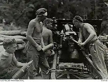 Gunners load and fire an artillery piece