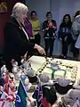 Betty Kitchener cutting cake at celebration of one million first aiders trained worldwide, Melbourne, June 2015