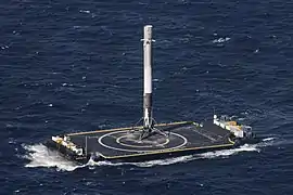 A landed Falcon 9 first stage on Of Course I Still Love You