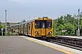 A Merseyrail Class 508 departs from the station.