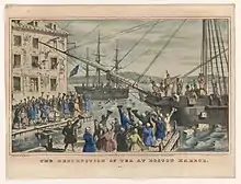 Two ships in a harbor, one in the distance. On board, men stripped to the waist and wearing feathers in their hair throw crates of tea overboard. A large crowd, mostly men, stands on the dock, waving hats and cheering. A few people wave their hats from windows in a nearby building
