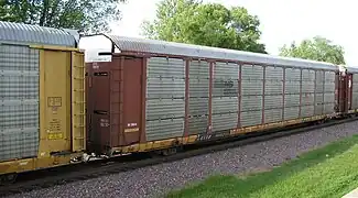 A Norfolk Southern autorack on a TTX flatcar