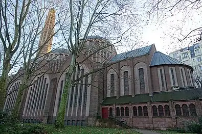 The side of the church, with bell tower, nave and apse.