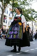 Galician woman with embroidered mantelo and saffron faldriqueira