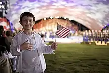 A boy holding an American flag during the 2009 National Memorial Day Concert