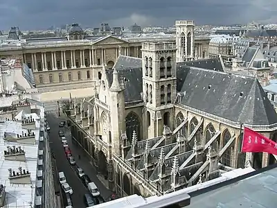 The church bell tower (foreground), with the Louvre in background and the campanile of the arrondissement city hall behind and to right.
