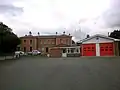 The station building and fire station in August 2014