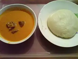 Image 28Fufu (right) is a staple meal in West Africa and Central Africa. It is usually served with some peanut soup. (from Culture of Africa)