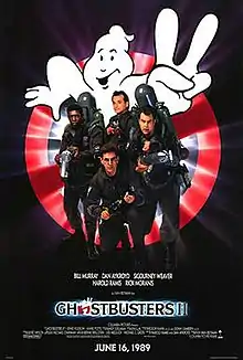 Bill Murray, Dan Aykroyd, Harold Ramis, and Ernie Hudson face the viewer. They are armed with slime throwing weapons resembling guns, with large tanks on their back. Behind them is a large logo of a "no ghosts" sign holding up two fingers. The logo "Ghostbusters II" is printed beneath them.