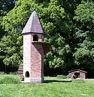 Brick tower with narrow wooden stair spiraling up the side