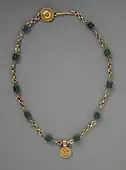 Necklace with a medallion depicting a goddess; 30–300 AD; green glass (the green beads) and gold; length: 43.82 cm; Los Angeles County Museum of Art