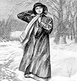 A young woman wearing a hat, scarf and long coat stands in a wintry scene, with snow on the ground and bare trees behind her.