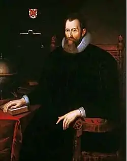 A baroque picture of a sitting man with a beard.