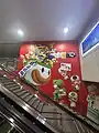A Mario-themed mural in Terminal 1 welcomes arriving passengers in different languages