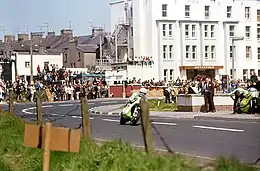 A motorcycle rider racing on a public road