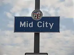 Mid City neighborhood sign located at the intersection of La Brea Avenue and the Santa Monica Freeway