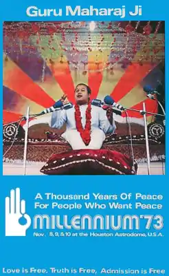A blue poster featuring an image of an Indian youth with short hair, talking, sitting on a sofa, his feet on a cushion, several microphones in front of him. Below the picture, the poster has white letters spelling "A Thousand Years of Peace For People Who Want Peace", below that – in larger letters – "Millennium '73", and below that in smaller writing "Nov. 8, 9 & 10 at the Houston Astrodome U.S.A."
