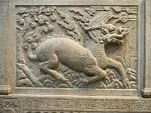 Image 61Gilin with the head and scaly body of a dragon, tail of a lion and cloven hoofs like a deer. Its body enveloped in sacred flames. Detail from Entrance of General Zu Dashou Tomb (Ming Tomb). (from Chinese culture)