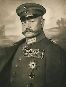  An old photograph of a man with a moustache in military uniform.