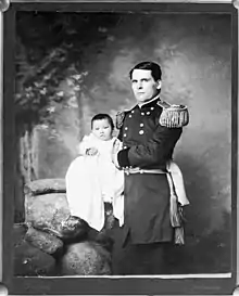 Gen. L. W. Colby holding Zintkála Nuni (Little Lost Bird), found alive on the snow-covered Wounded Knee field four days after the massacre, still tied to her dead mother's back
