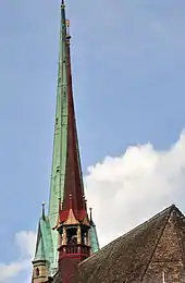 The 27.1 metres (88.9 ft) high ridge turret of Predigerkirche Zürich, its 96 metres (315 ft) clock tower in the background.