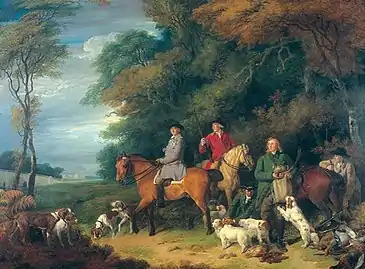 Five men and three horses at the edge of a wood along with a large group of dogs.