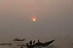 Rising sun and busy fishermen at Puri Beach