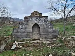 Ruined memorial spring in the village