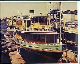 Dry docked 1960s in her 1937 yellow and green livery and short diesel funnel.