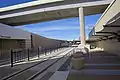 View north from the north pedestrian crosswalk. North of the station, the TEXRail tracks pass underneath a taxiway which permits aircraft to cross between the east and west sides of the airport.