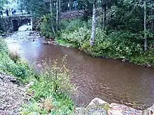 The Eau Rouge river as it passes the interior of the Circuit de Spa-Francorchamps, close to the pit complex