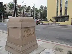 West Adams concrete marker in front of the Golden State Mutual Life Insurance Building, 2021.