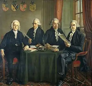 Group portrait of the four chief commissioners of the ports, quays and cranes in Amsterdam, sitting around a table
